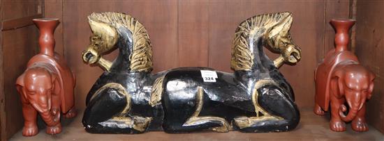 A Chinese carved wood horse group and a pair of lacquered elephant candlesticks